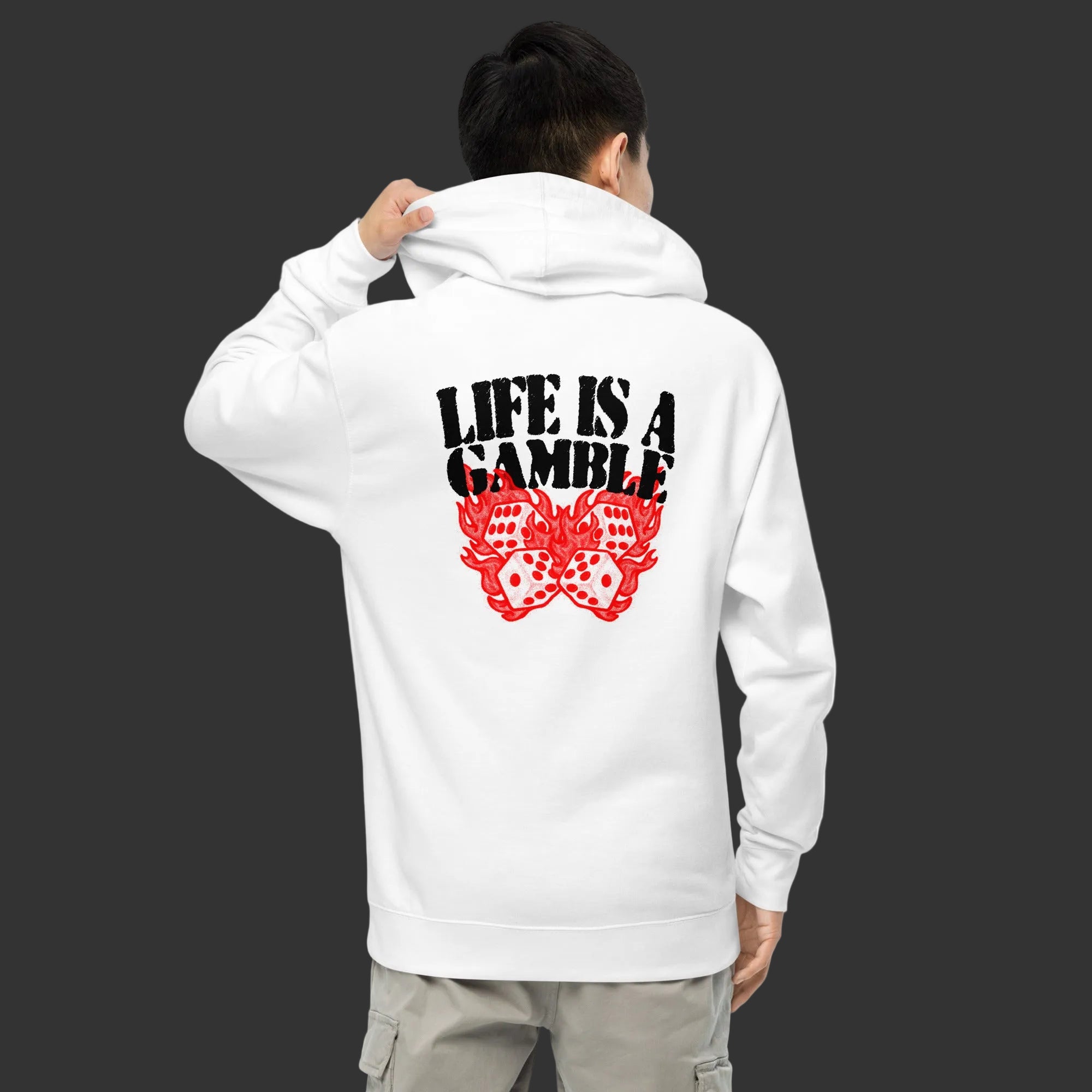 Person wearing a white hoodie with 'Life is a Gamble' text and red dice design on the back.
